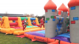 santa's running through inflatable obstacles